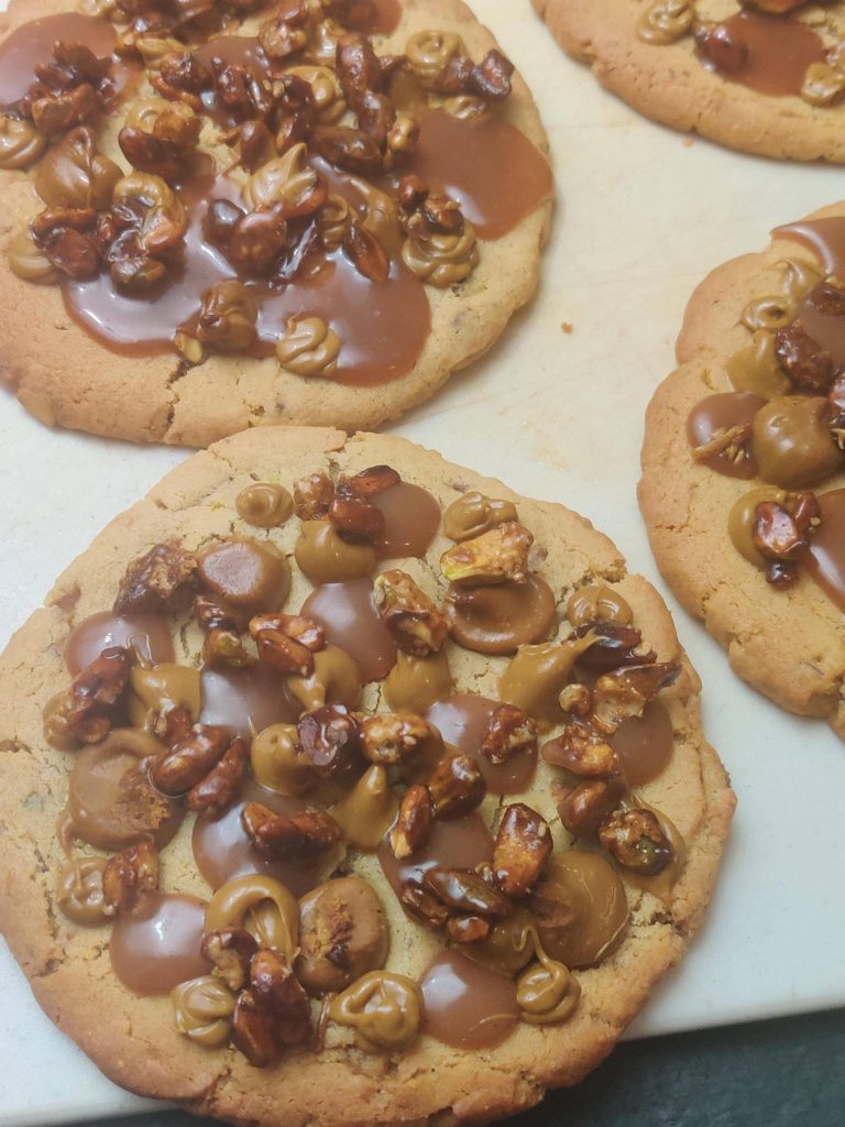 Giant Pistachio Caramel Cookies! Pistachio cookies, salted caramel, pistachio praline, caramelized pistachios.