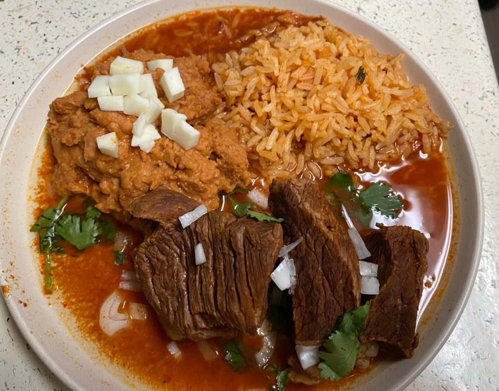 Birria with chorizo refried beans and rice, so full of flavor.