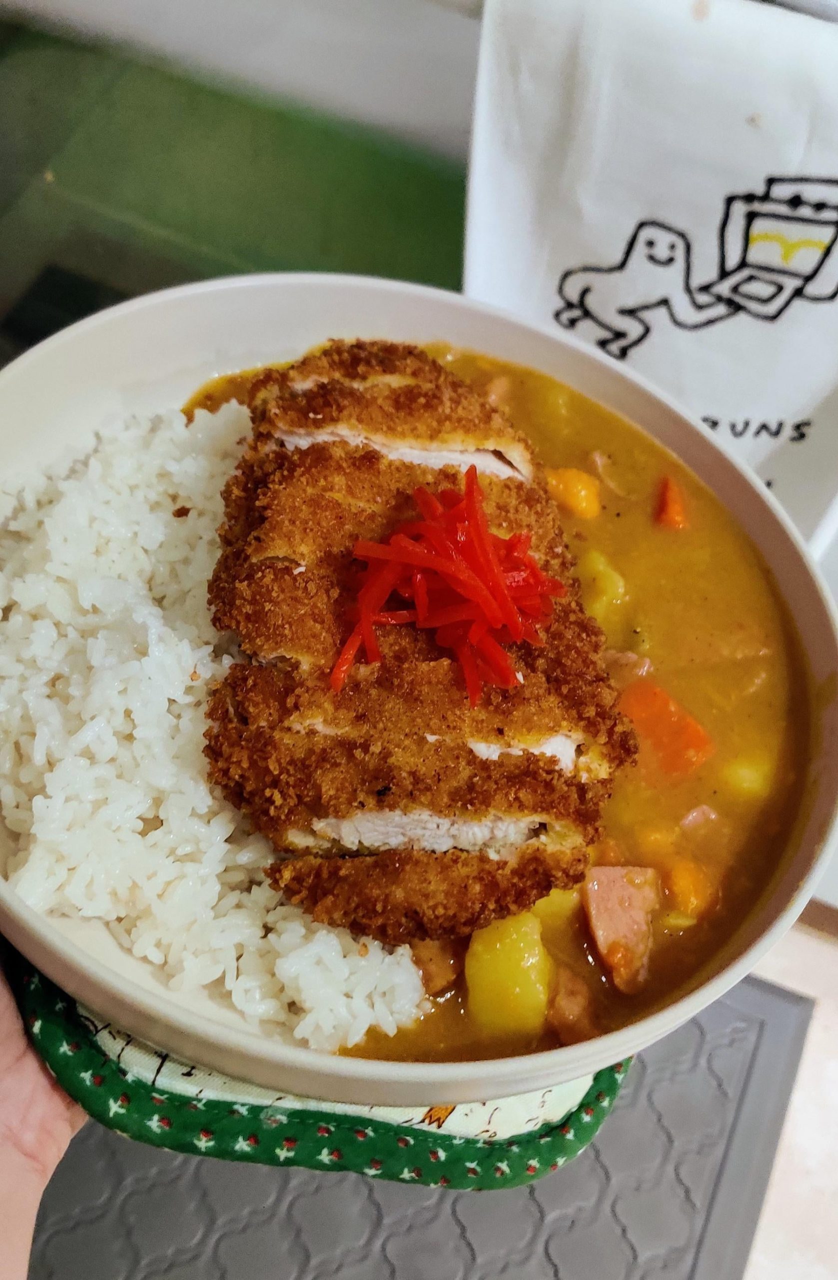 Tonkatsu and Japanese curry. Garnished with pickled ginger. Dining