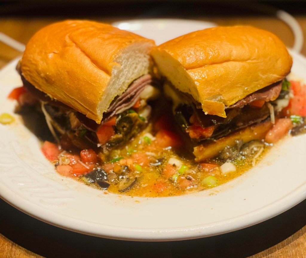 Messy, sloppy, roast beef sandwich with Provolone, homemade hoagie, and aioli.
