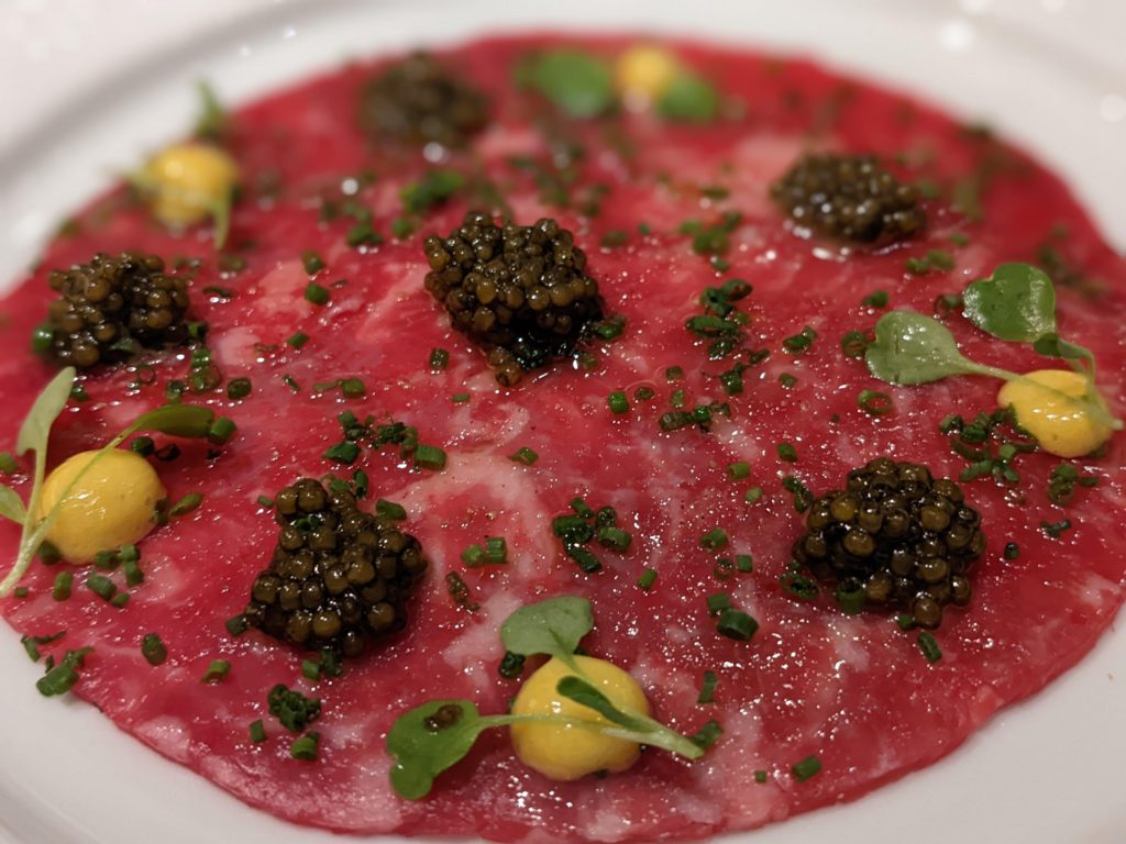 Wagyu carpaccio with hybrid sturgeon caviar and champagne sabayon. At Emeril's, Nola.