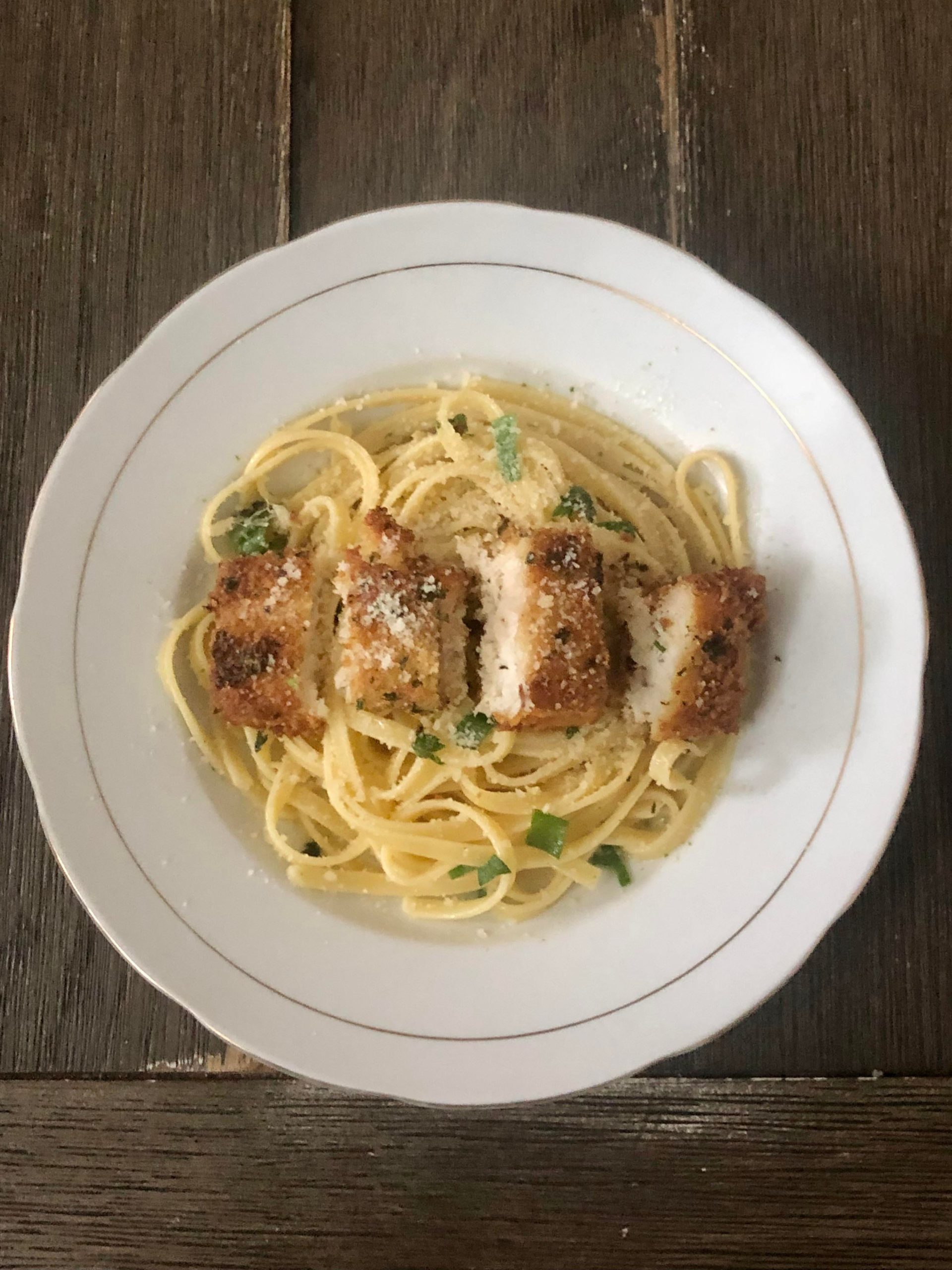 garlic butter fettuccine with breaded dory, topped with more garlic