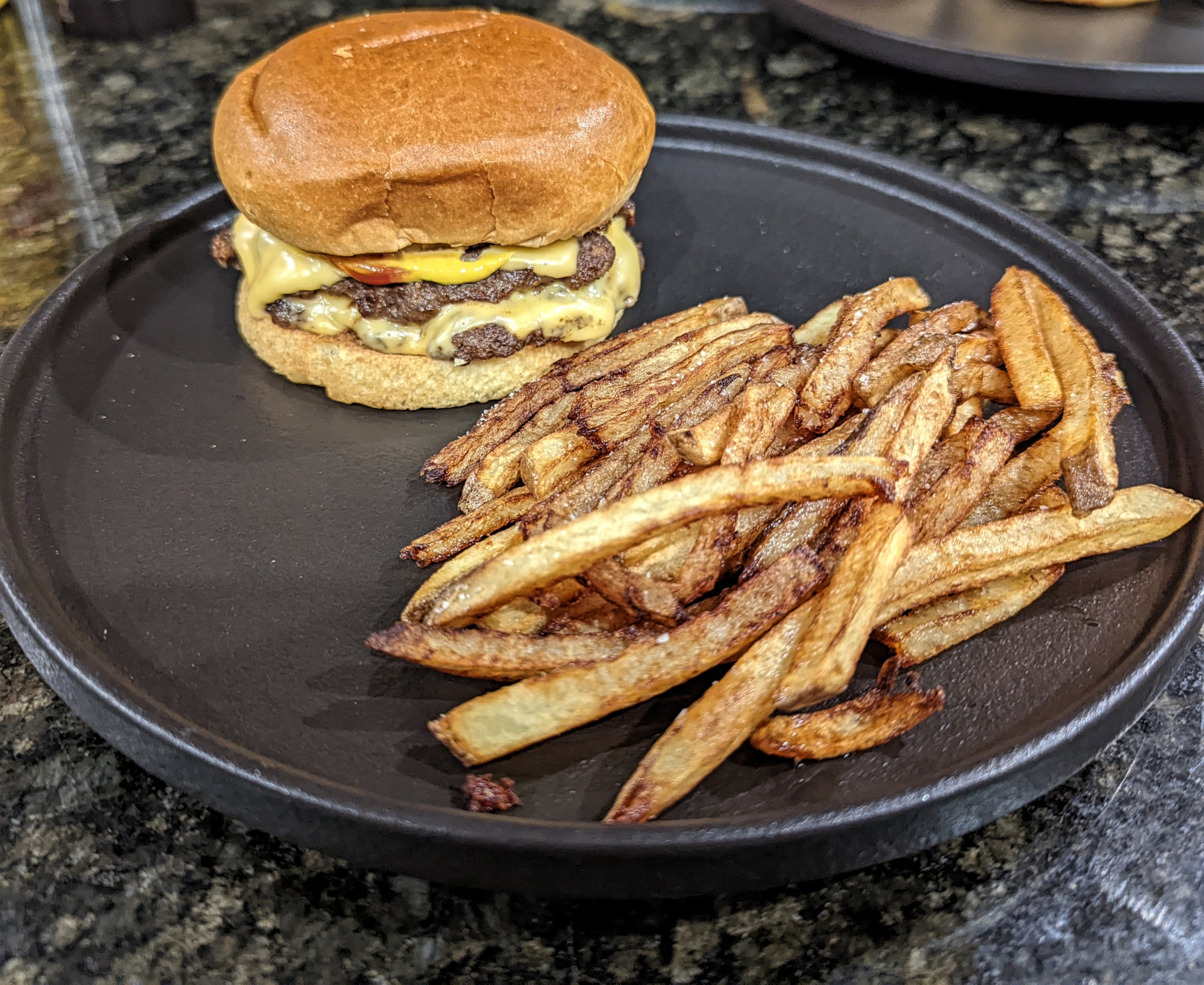 Ground brisket and short rib patties on fresh brioche with hand cut