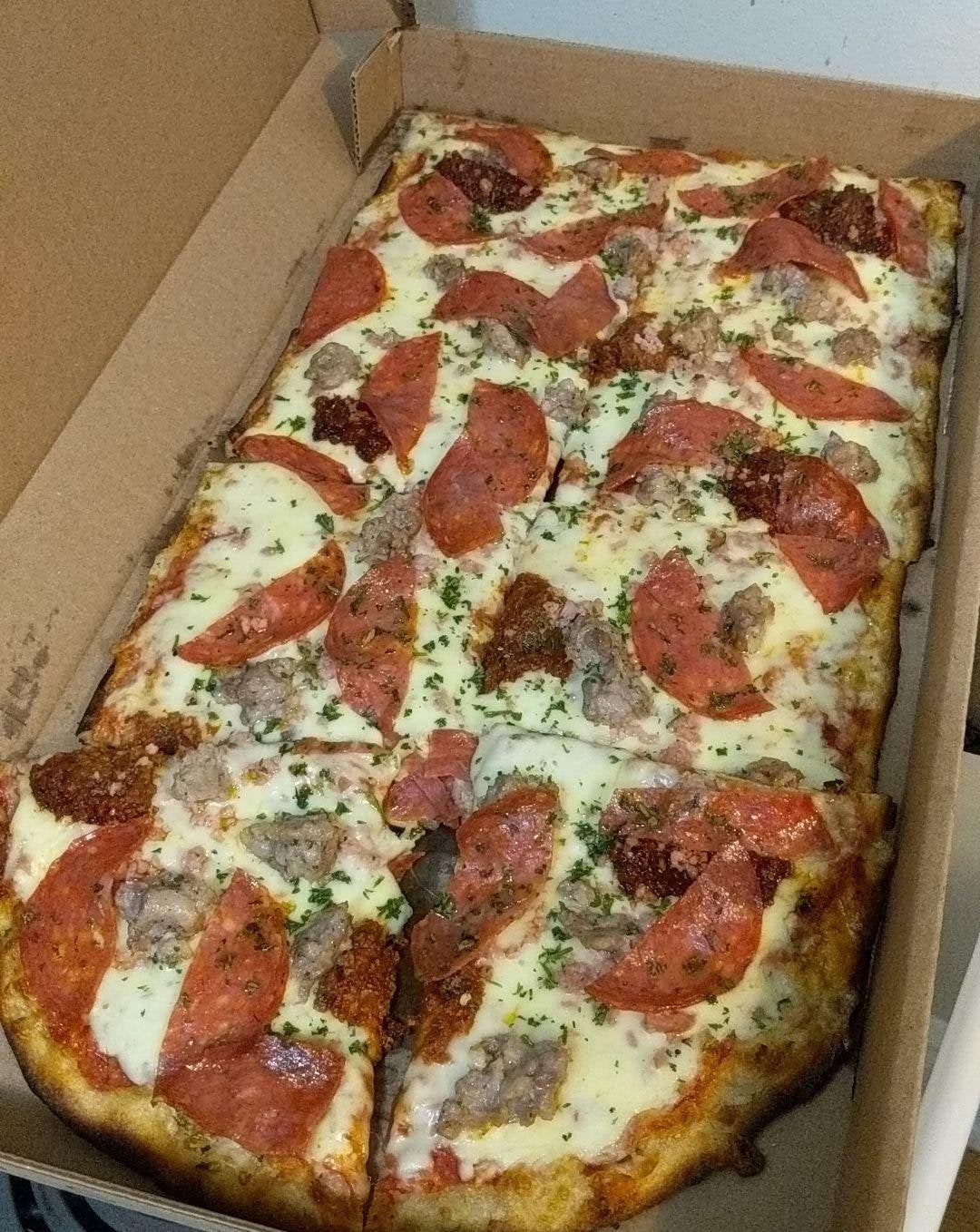 Half meter of spicy meat pizza from a local pizza shop. (Farinella