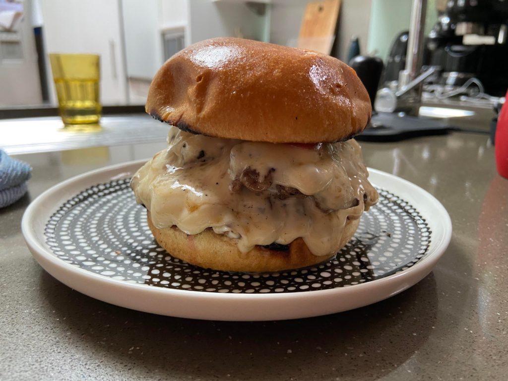 A very cheesy burger, very very very cheesy, as cheesy as the mask (a movie)