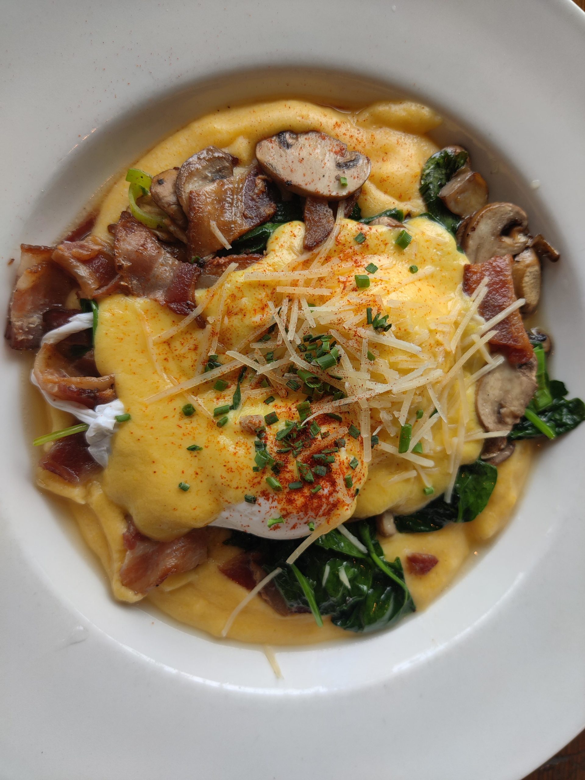 Ultimate cheesy polenta, bacon, sauteed mushrooms and spinach topped