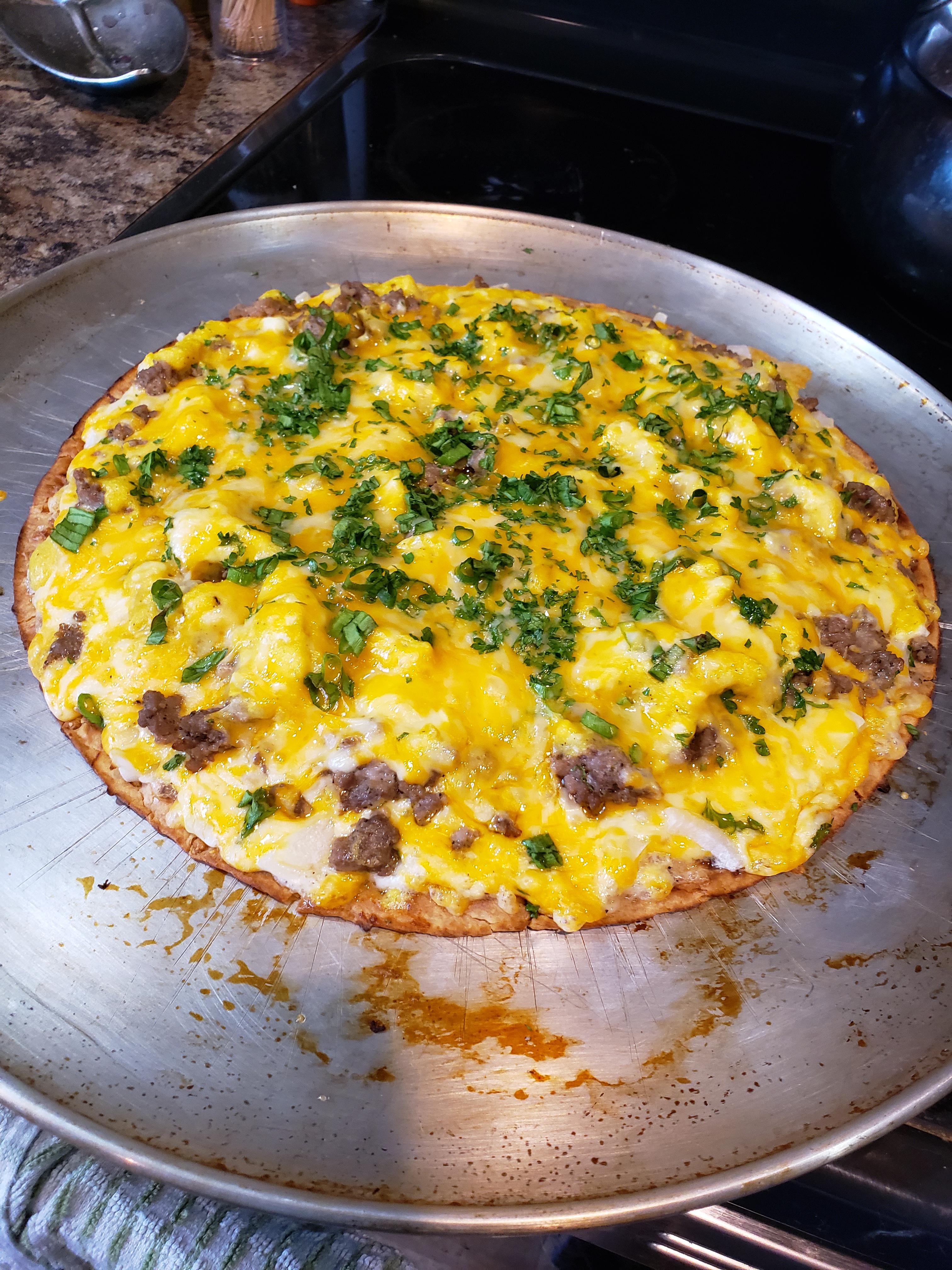 Breakfast pizza. Ranch base, thin sliced onion, Colby jack cheese