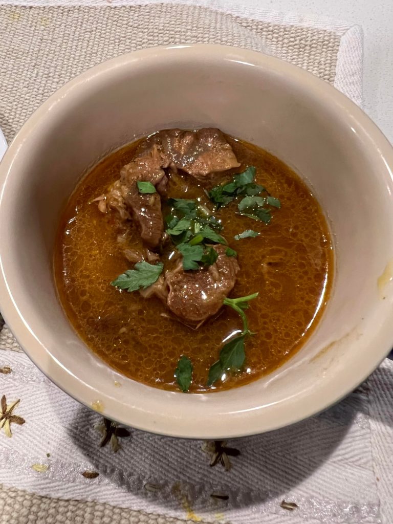 Pakistani beef stew- Nihari. Slow cooked beef shank. Served with naan.