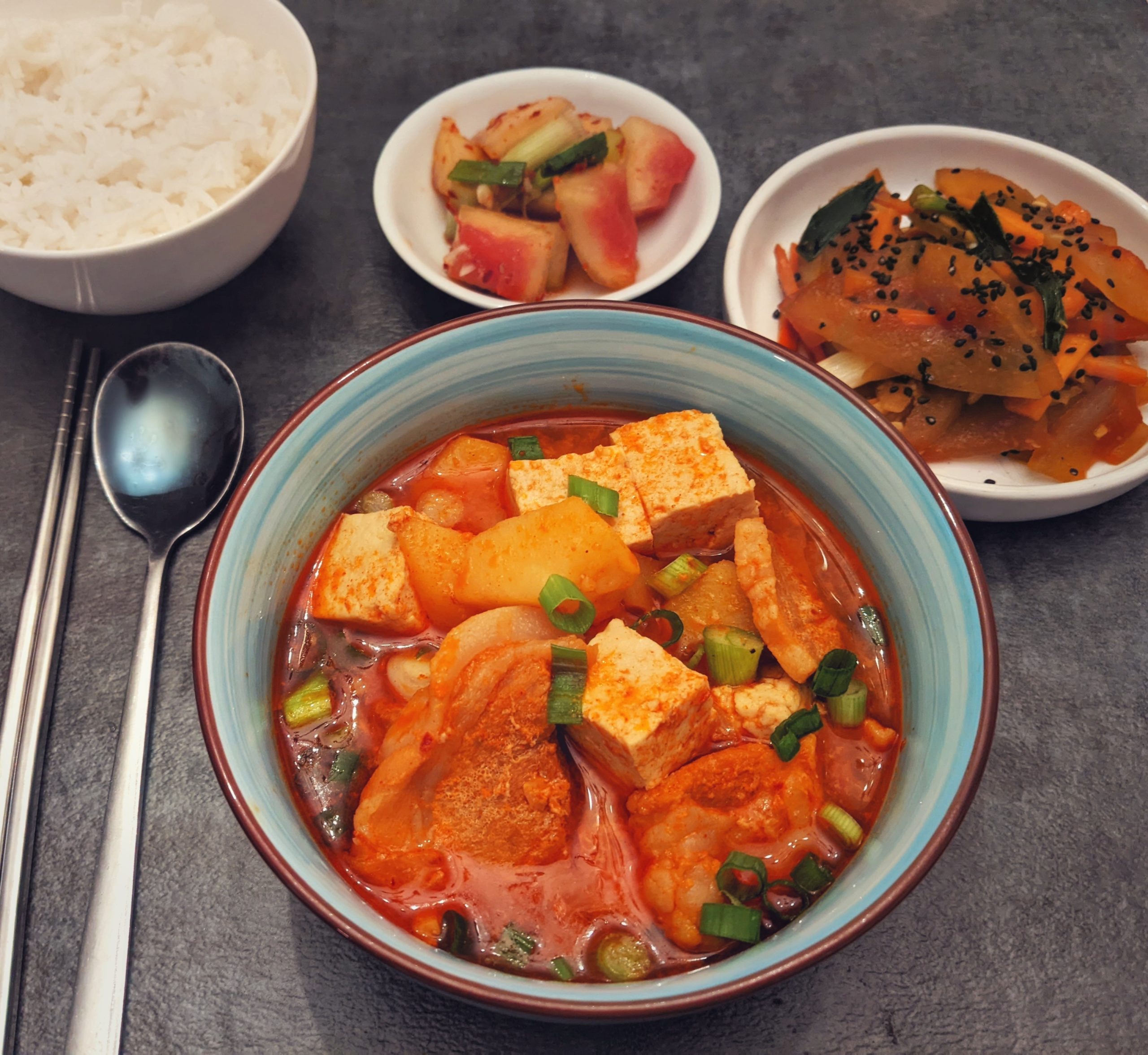 Dwaejigogi jjigae (spicy pork belly soup), watermelon rind kimchi, stir