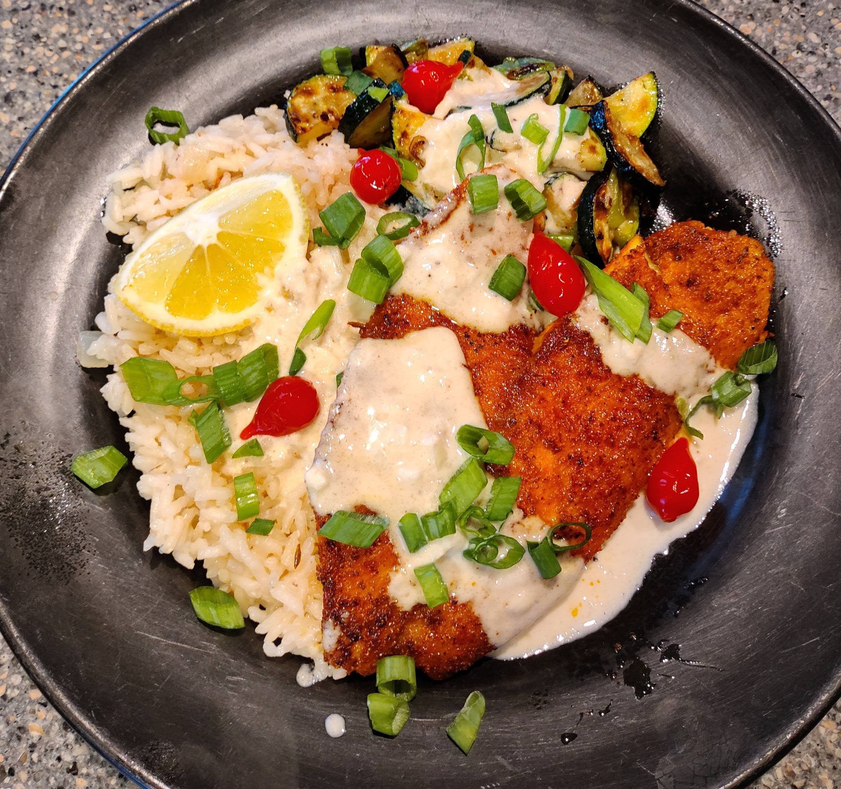 Shawarma seasoned tilapia with sauteed zucchini and caramelized onion