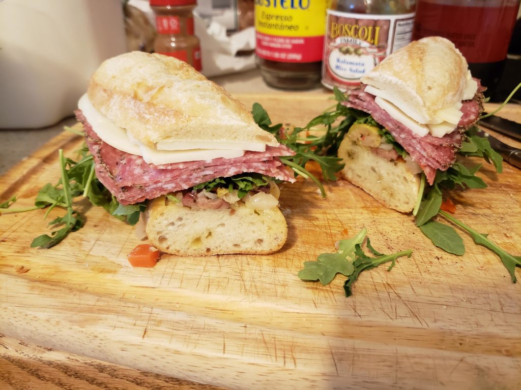 3 types of salami, provolone, arugula and olive salad