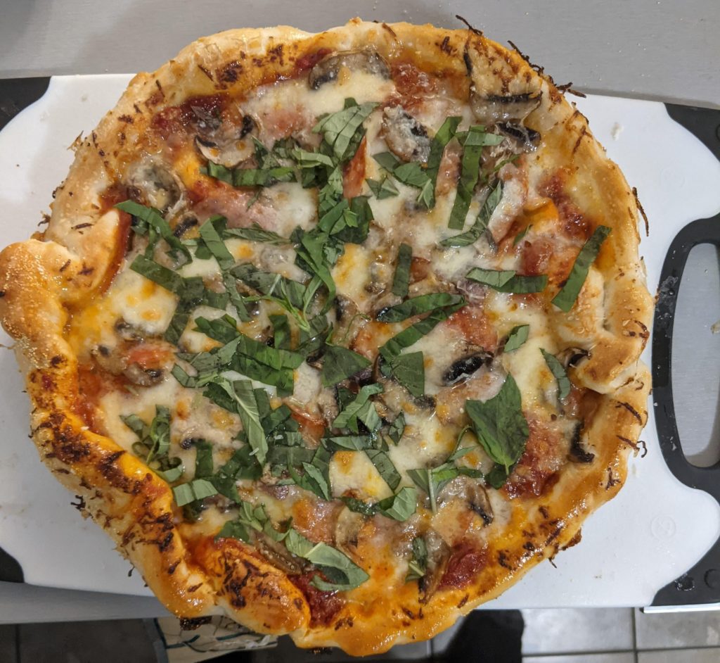 pepperoni, mushroom, anchovy, and basil pizza.