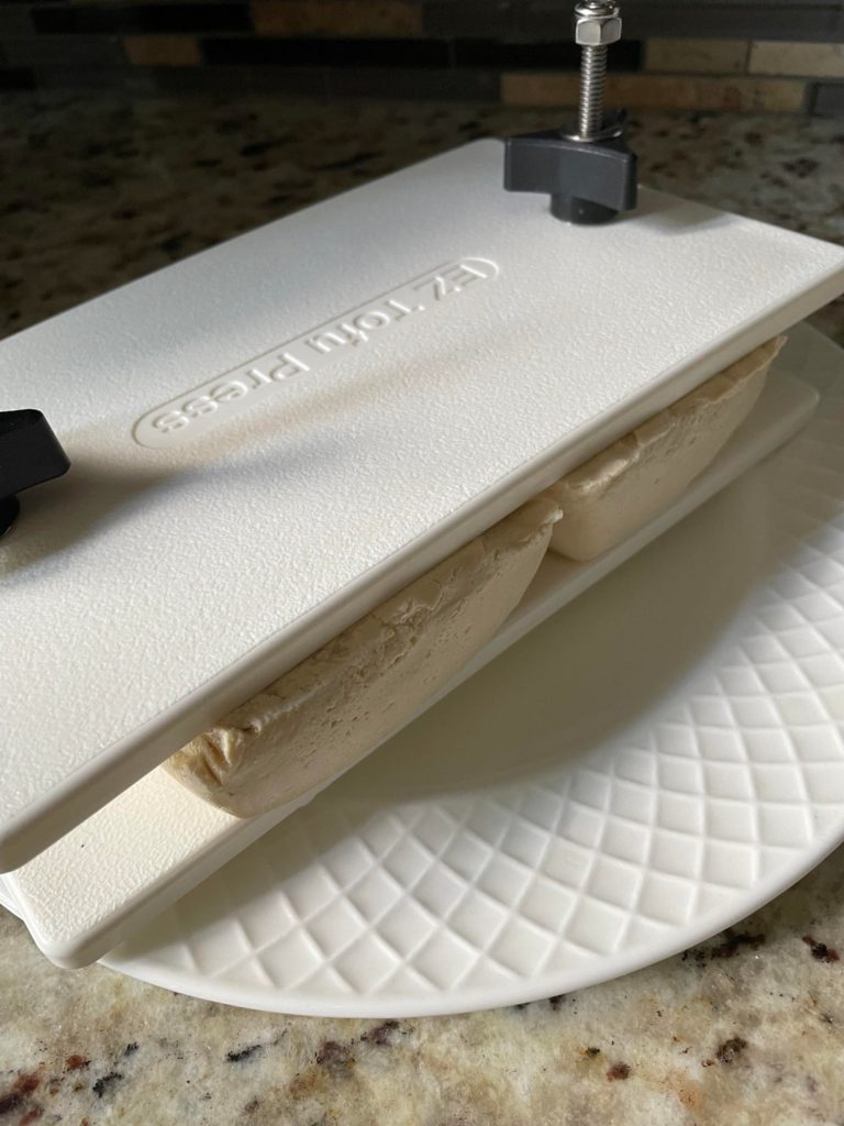 I’ve had this tofu press for a few years and I love it! Never fails me.. I know it’s meant for one in the middle but I flip it and add 2!