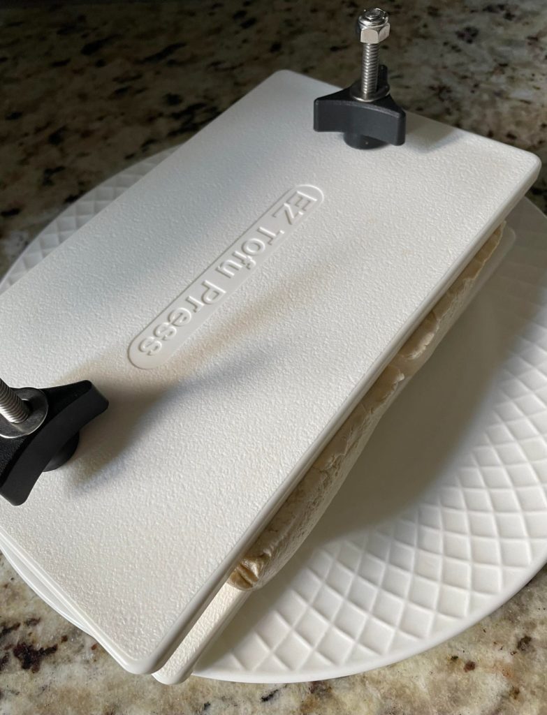 EZ Top Tofu Press purchased from Amazon a few years ago. I manage to use 2 tofu blocks by flipping it around. Highly recommend this product!!