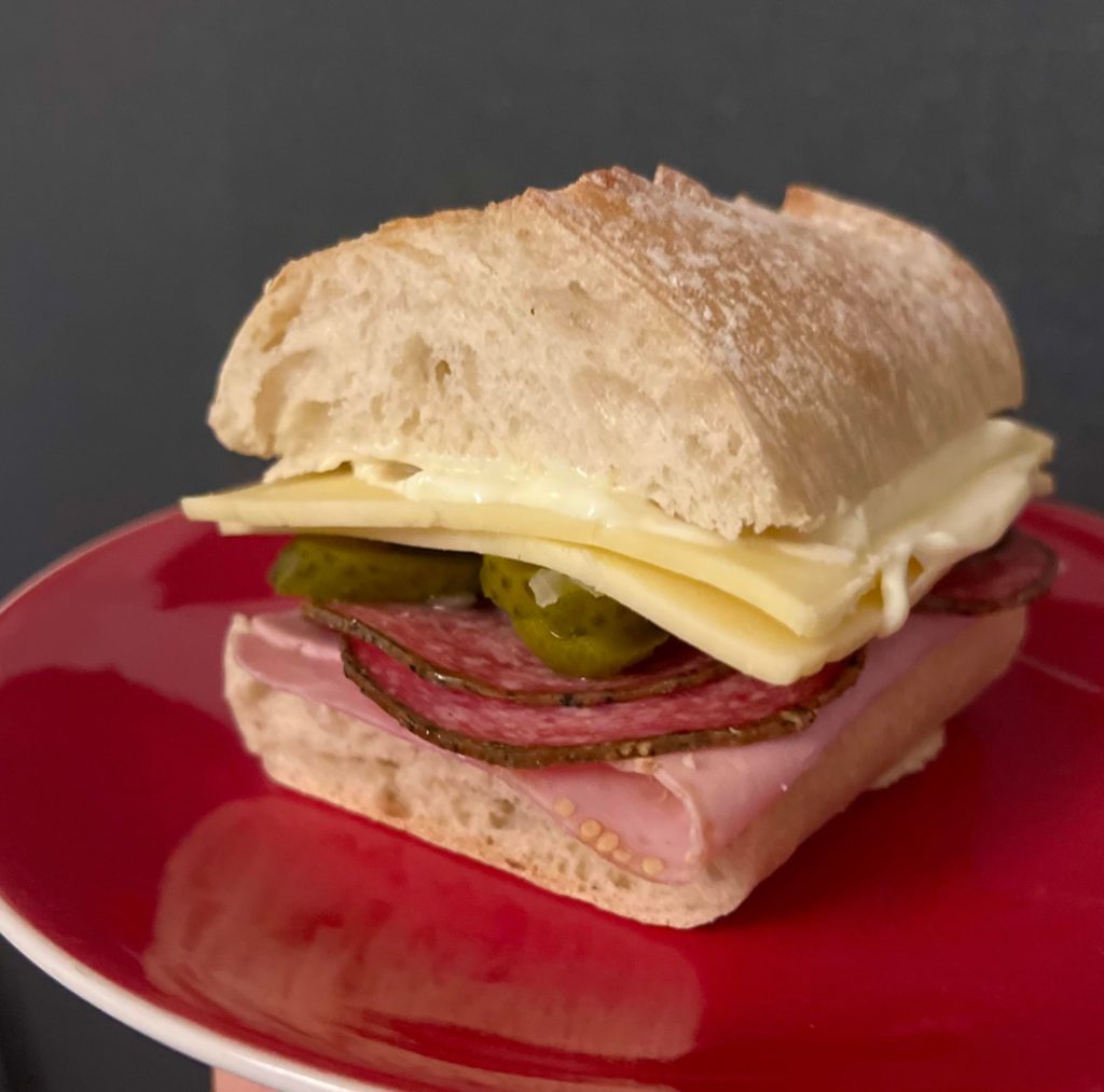 Honey ham, peppered salami, cheddar, pickles and mayo on a ciabatta baguette.