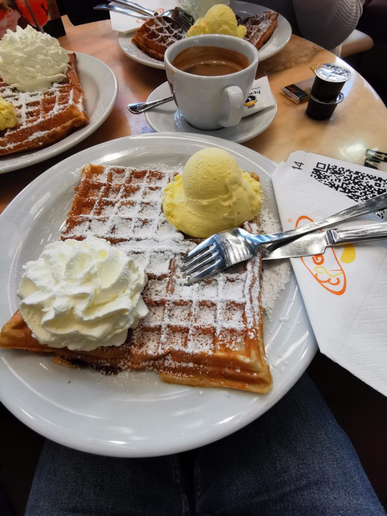 Waffles with whipped cream and vanilla ice cream