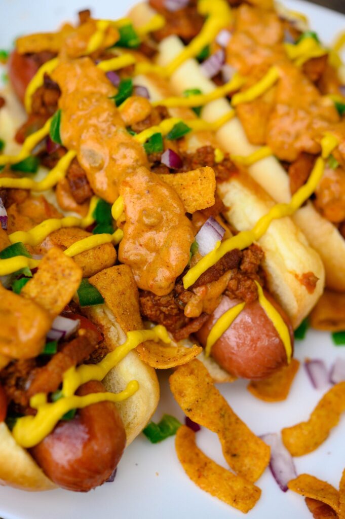 [homemade] chilli cheese dogs and seasoned fries.