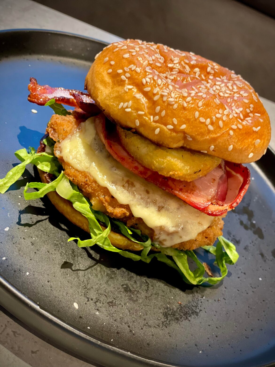 Ultimate homemade chicken burger with bacon, cheese & a hash brown