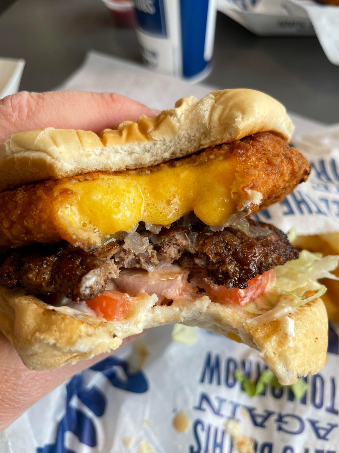 A burger topped with a burger sized, fried cheese curd. [OC]
