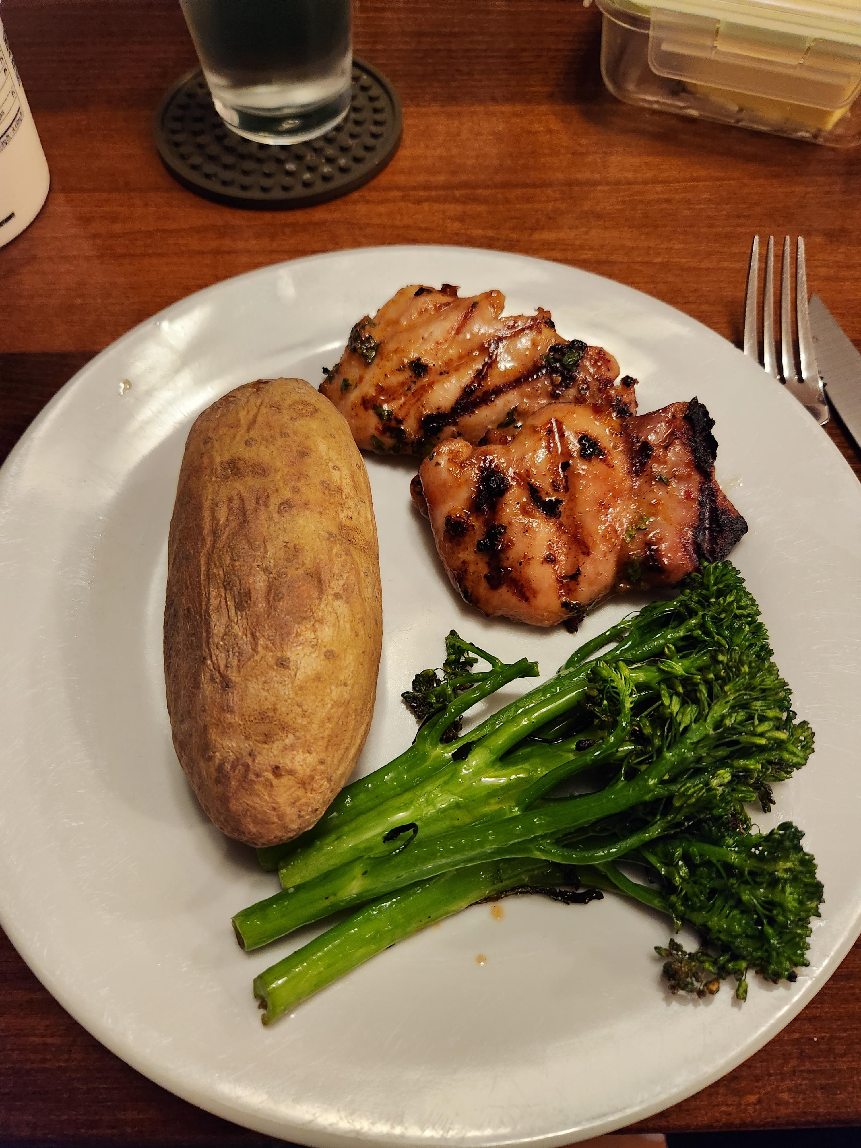 Grilled thai flavored chicken thighs, broccolini, and a baked potato