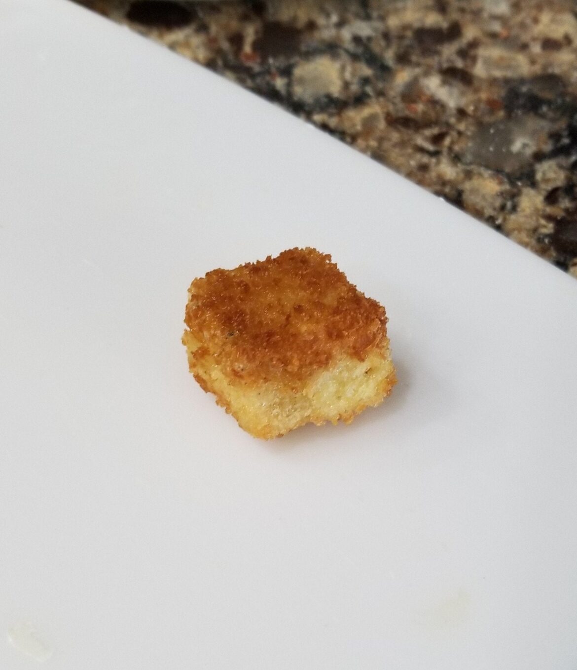 Fried marinated tofu. Marinate tofu, into cornstarch, into egg wash, into panko. Fry in shallow oil.