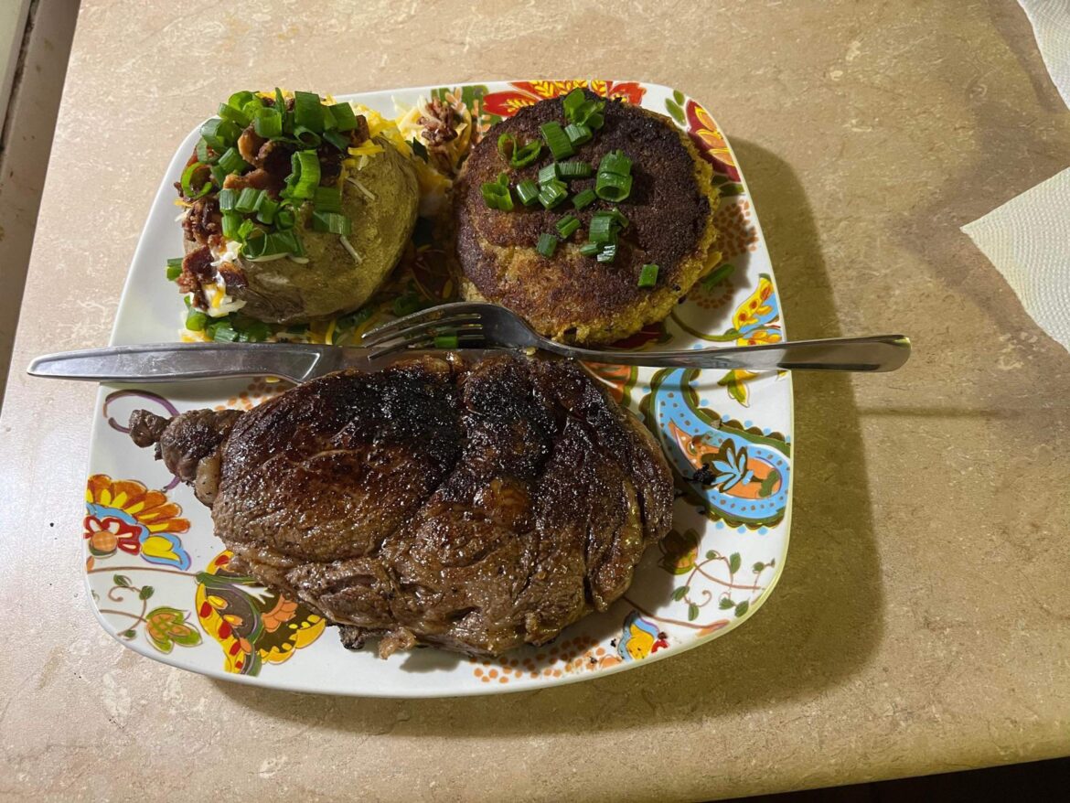 Anniversary dinner of ribeye steak, too big homemade crab cake and loaded baked potato.