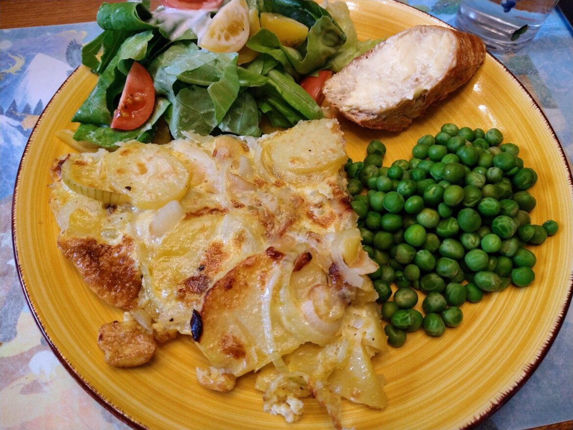 Bacalao tortilla (salt cod and potato omelet), with salad, peas and bread.