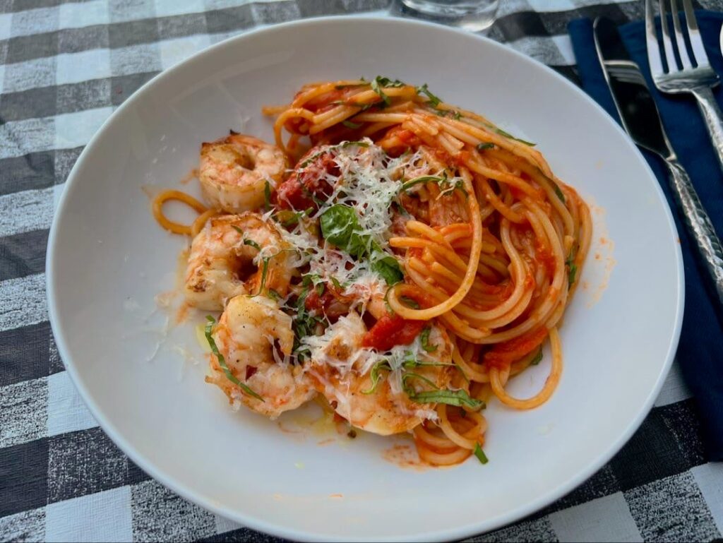 soaghetti tossed with roasted cherry tomatoes, garlic, a splash of pernod. garnishes with basil and asiago. side of seared shrimp