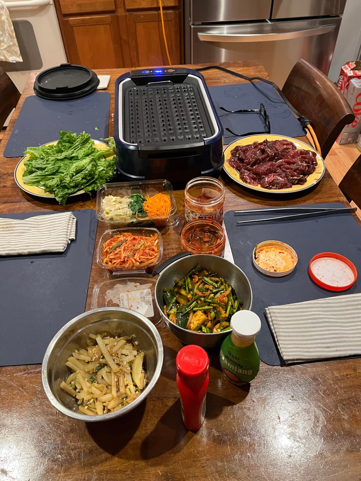 It’s BBQ night. Banchan in steel bowls made by me. Other banchan made by nice people at the international market.