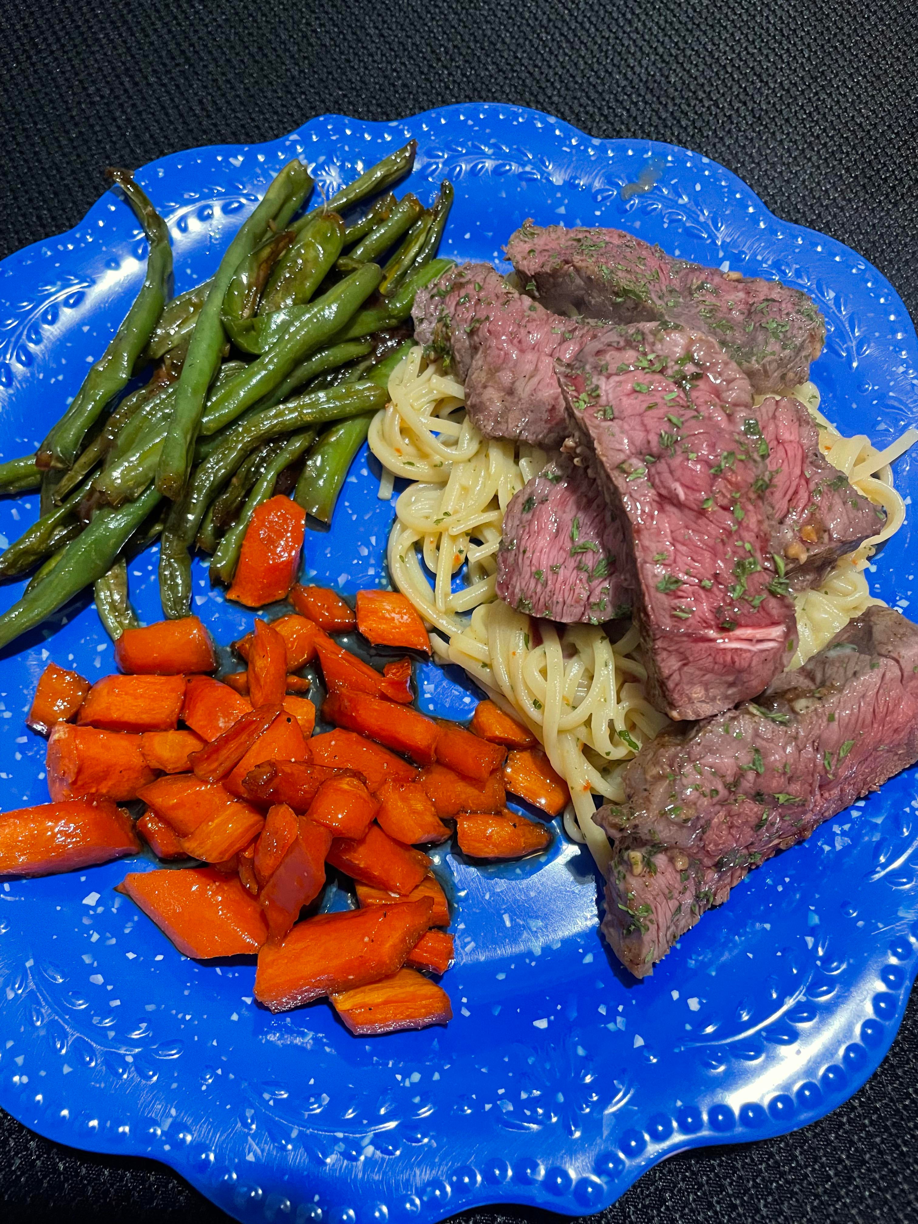 Spicy garlic green beans, sweet glazed carrots, steak over garlic parm