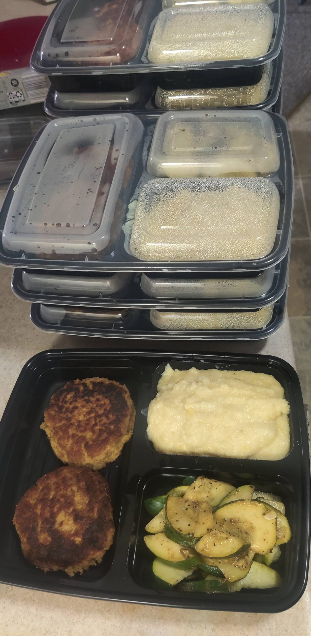 Spicy tuna patties with lemon pepper zucchini and cheesey grits