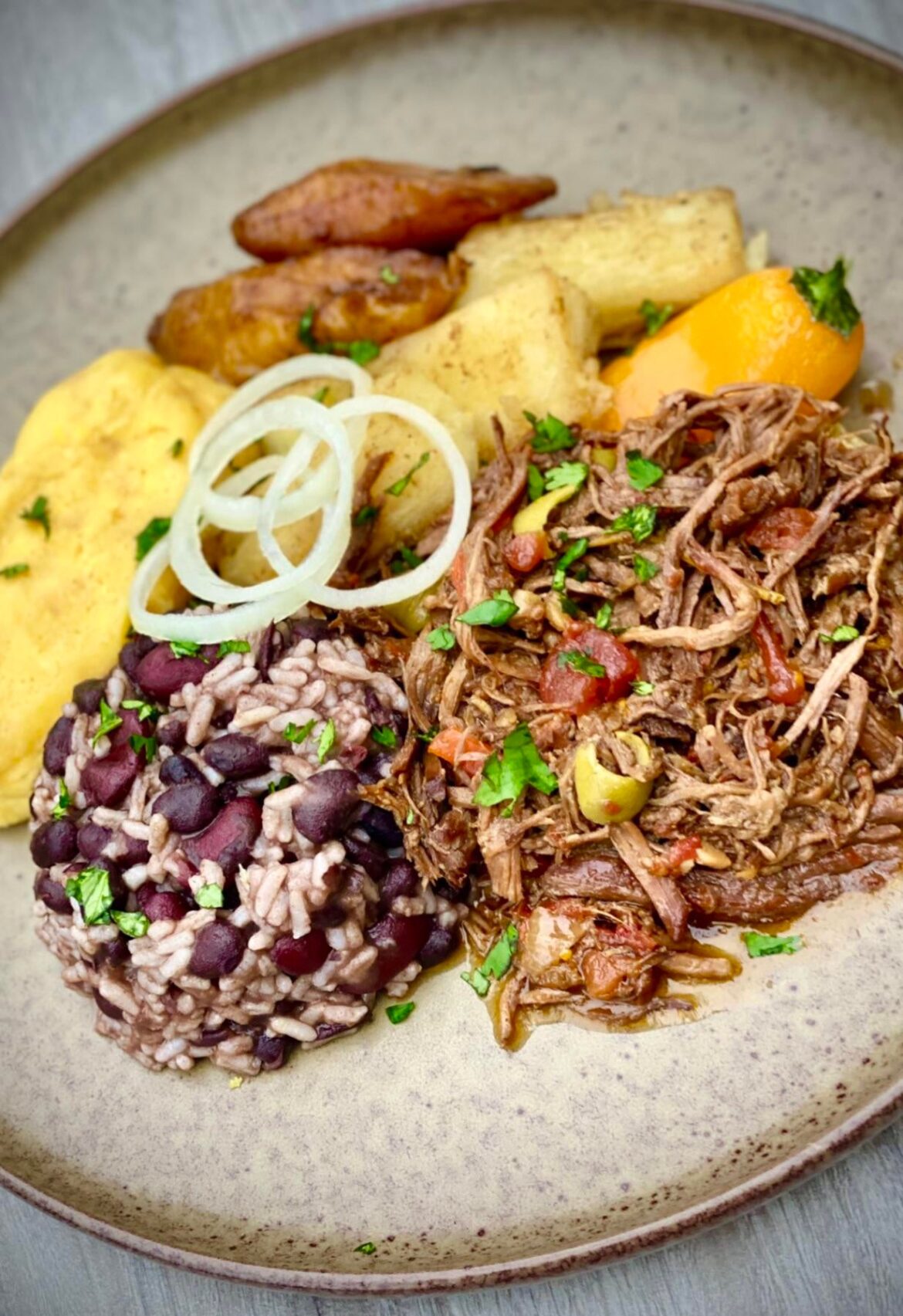 Ropa Veja with black beans and rice, tamales, pan fried yuca, sweet plantains. Just like grandma used to make.. [homemade]