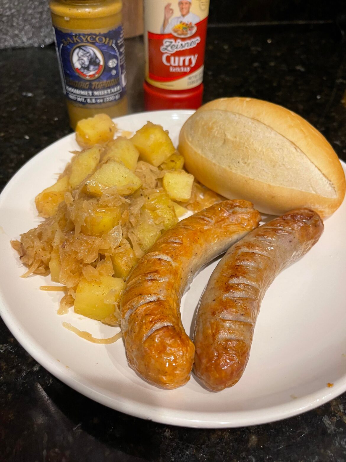 Brats with sauerkraut and potatoes.