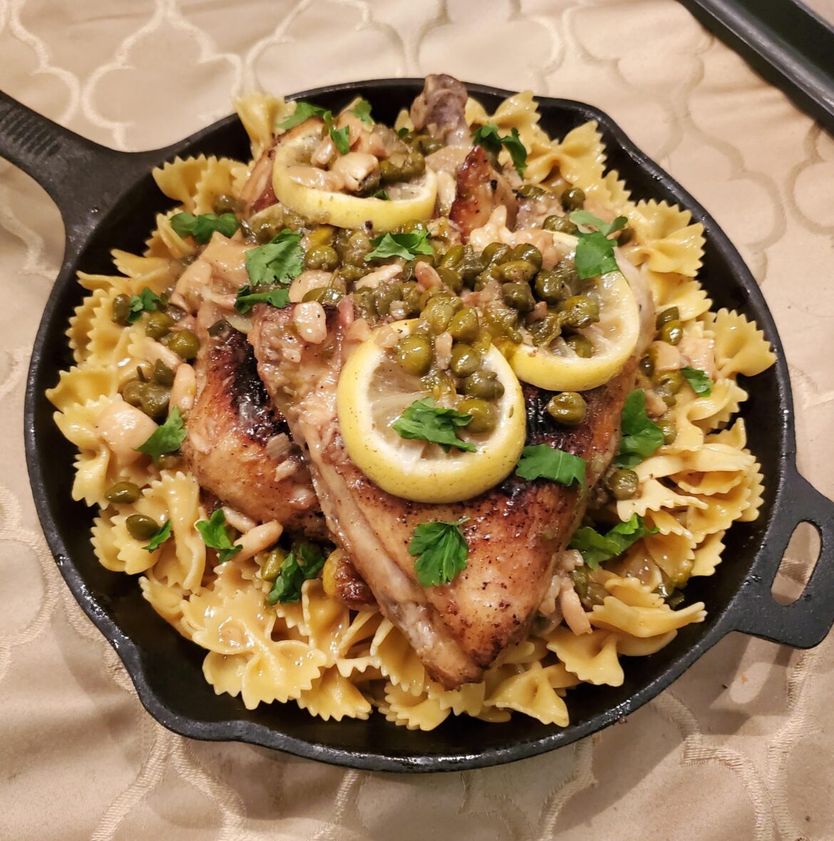 Braised chicken leg quarters, lemon caper butter farfalle pasta.