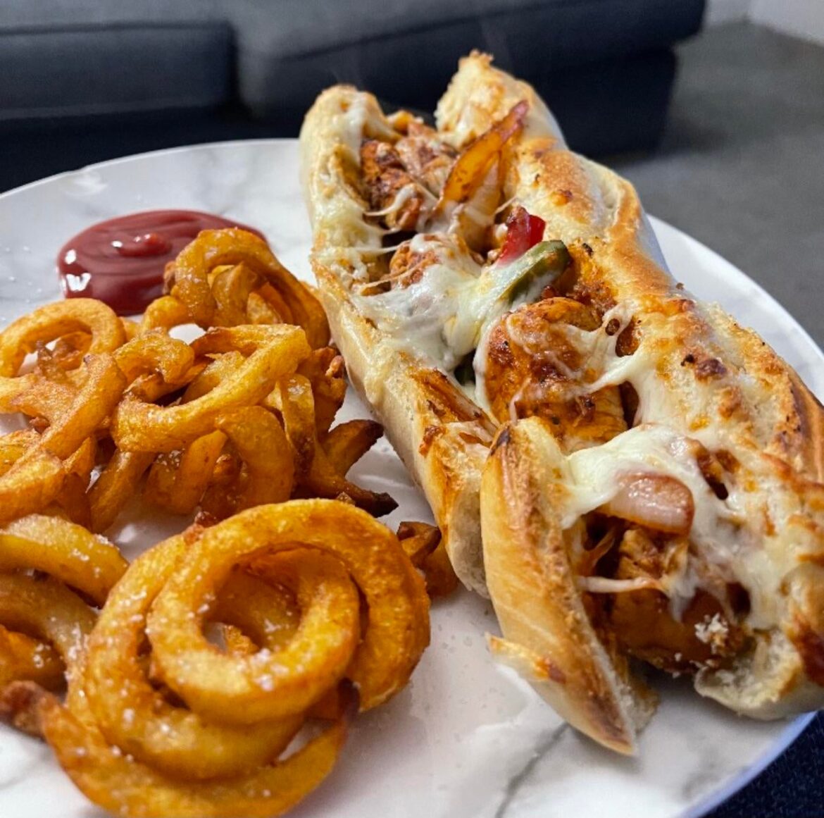 Cajun chicken baguette and curly fries