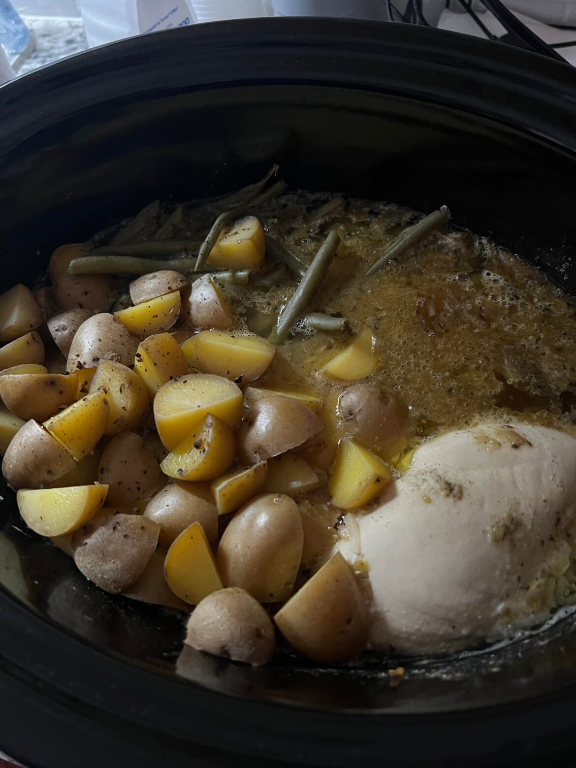 Boneless chicken breast with potatoes green beans Lipton onion soup mix vegetable broth and half a can of beer.