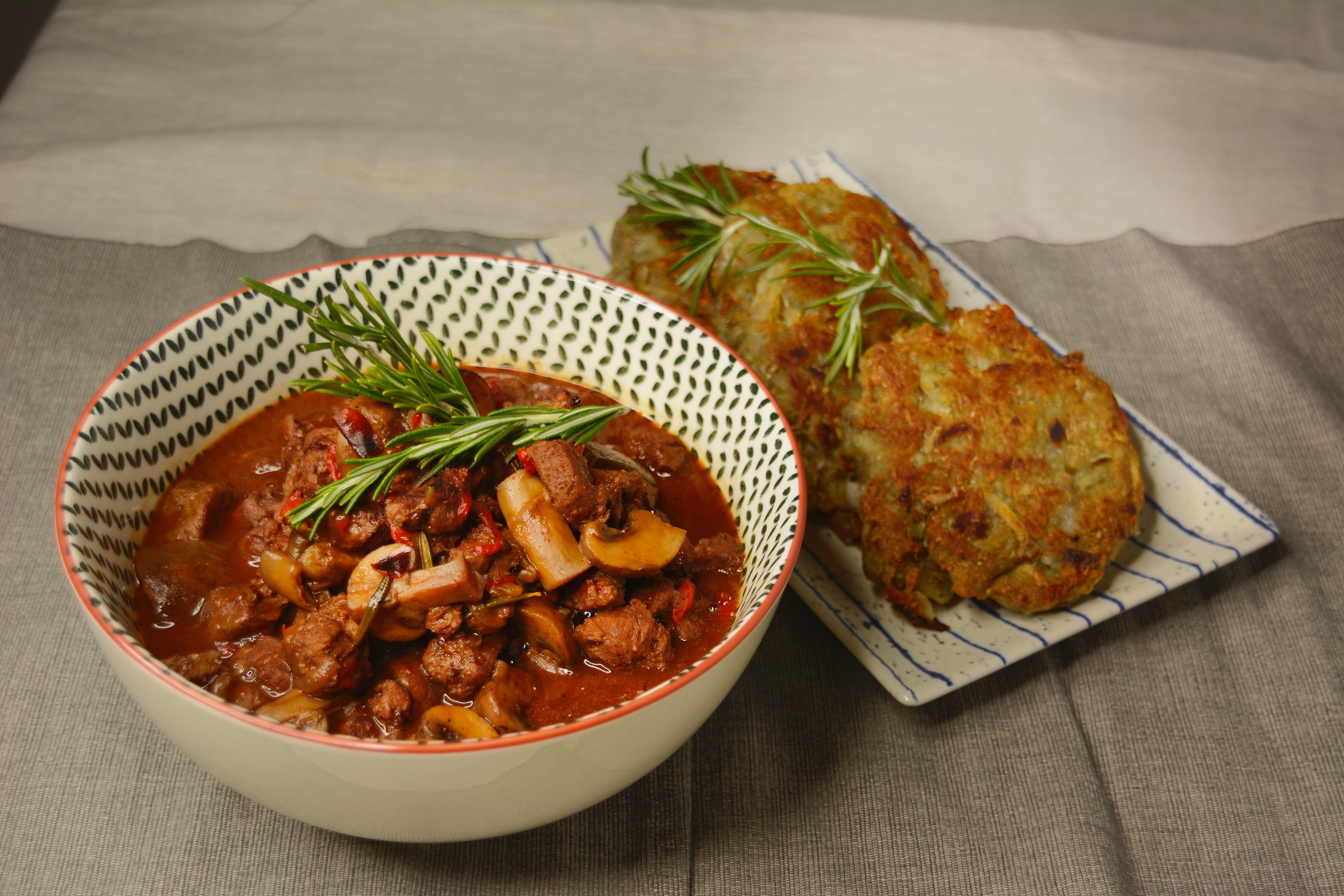 goulash from soy protein and mushrooms, served with potato fritters