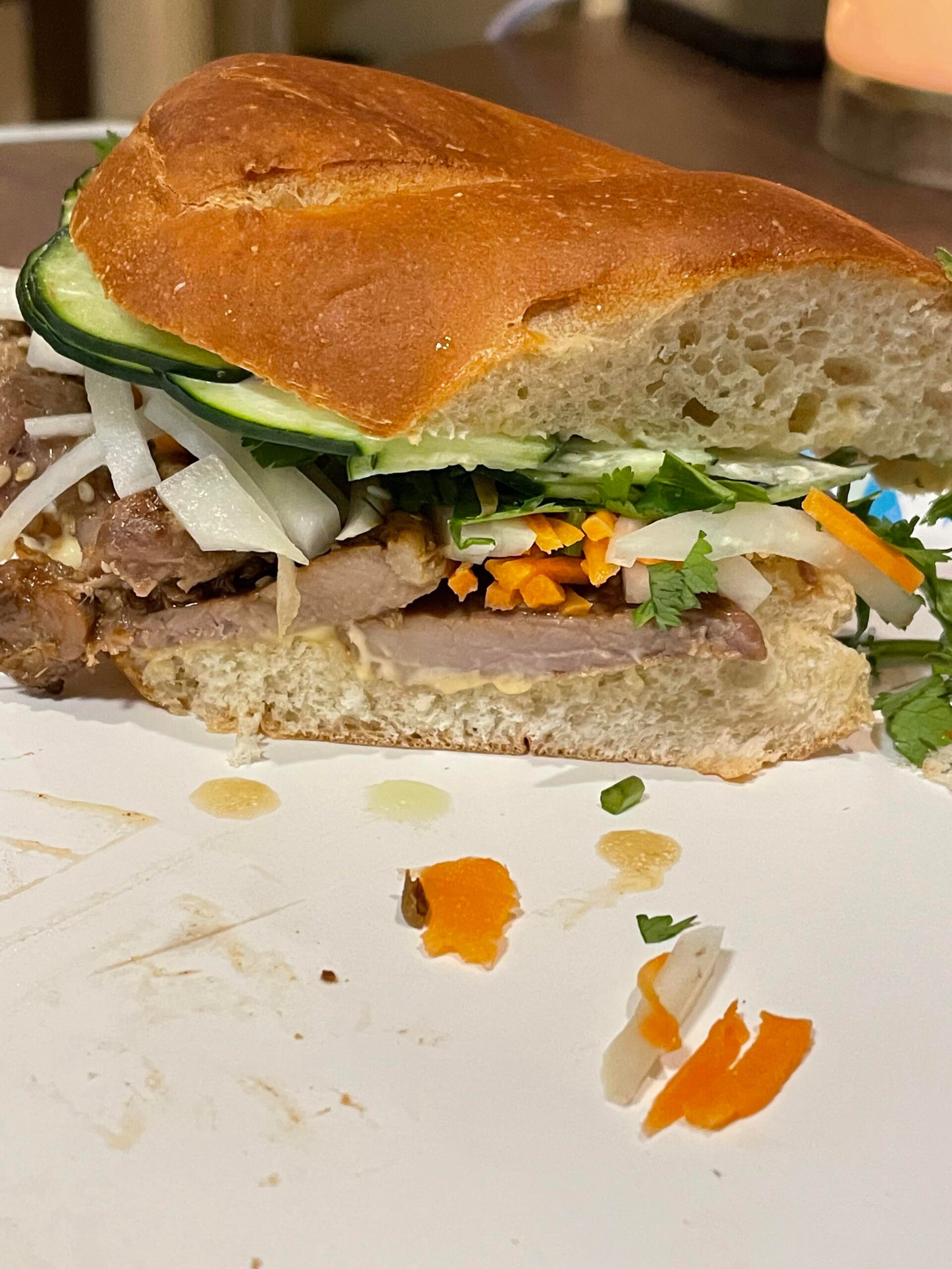 Pork banh mi with cucumbers, pickled daikon, and pickled carrots. Mayo