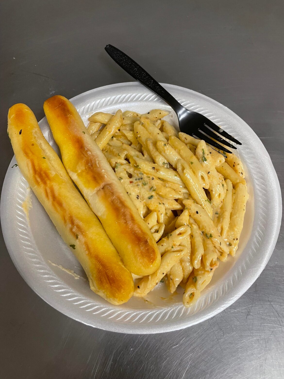 Pasta with Alfredo sauce and breadsticks