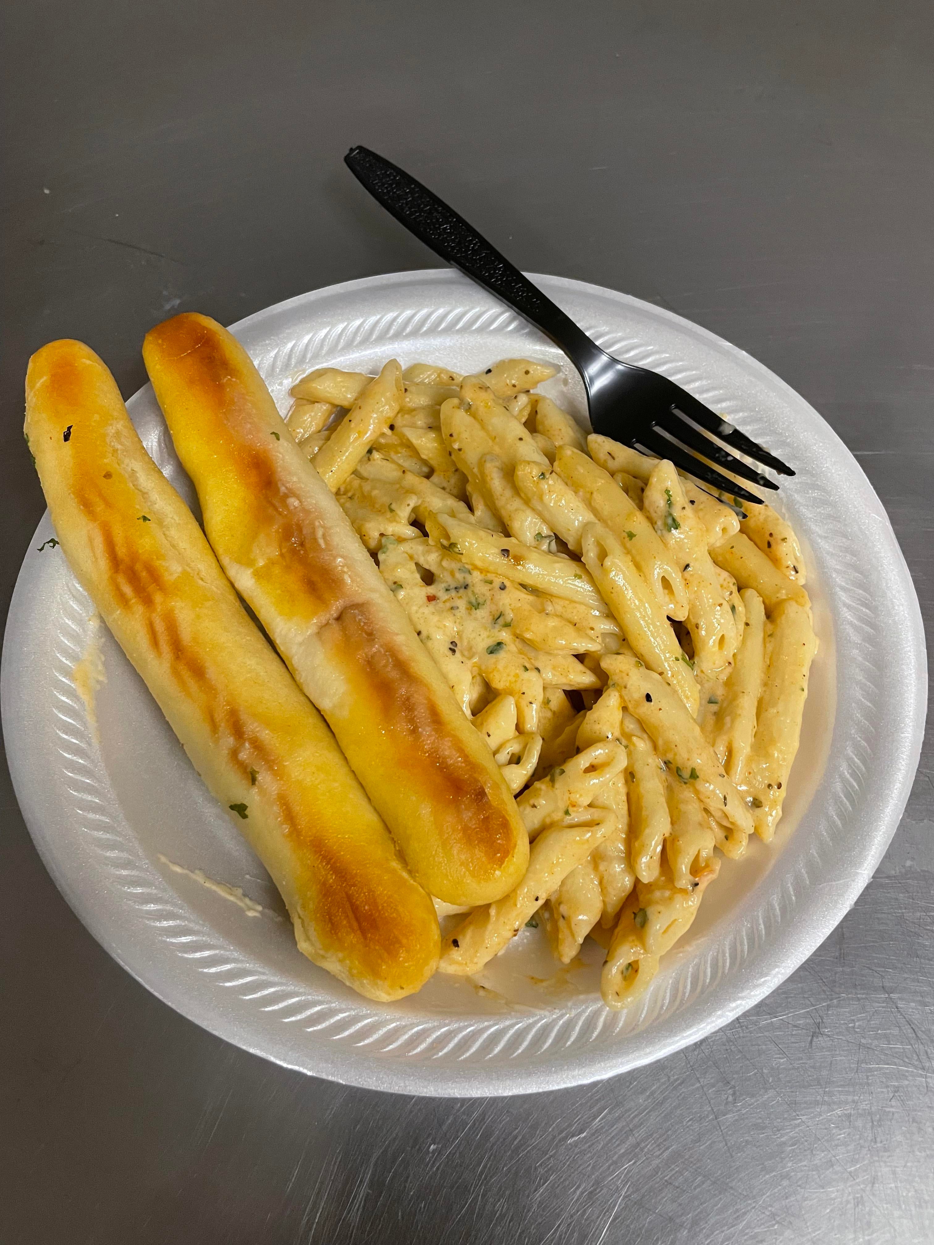 Pasta with Alfredo sauce and breadsticks Dining and Cooking