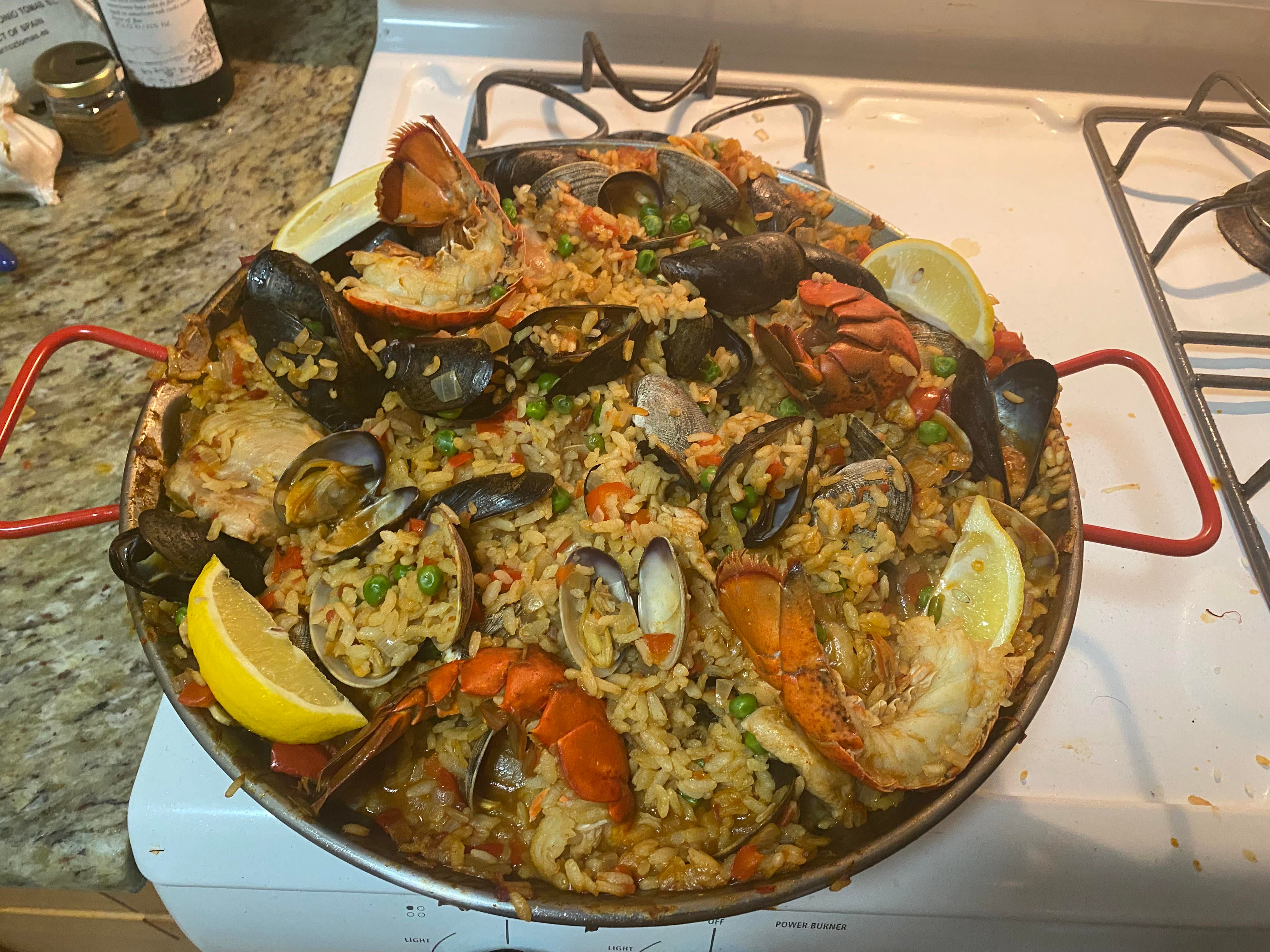Paella Valenciana with Rabbit, Mussels, Clams, and Lobster Dining and