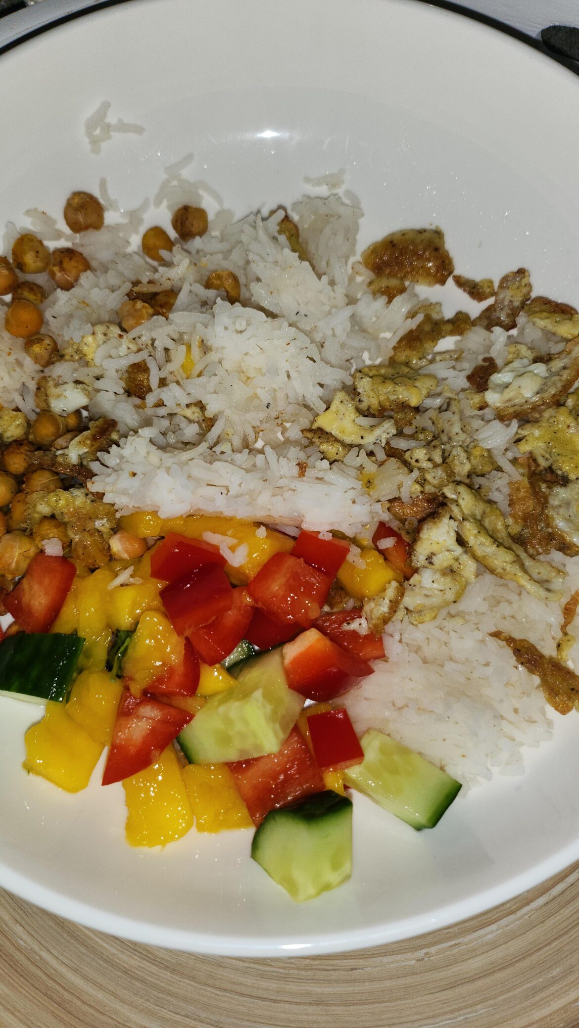 Homemade egg fried rice with mango salasa and chickpeas.