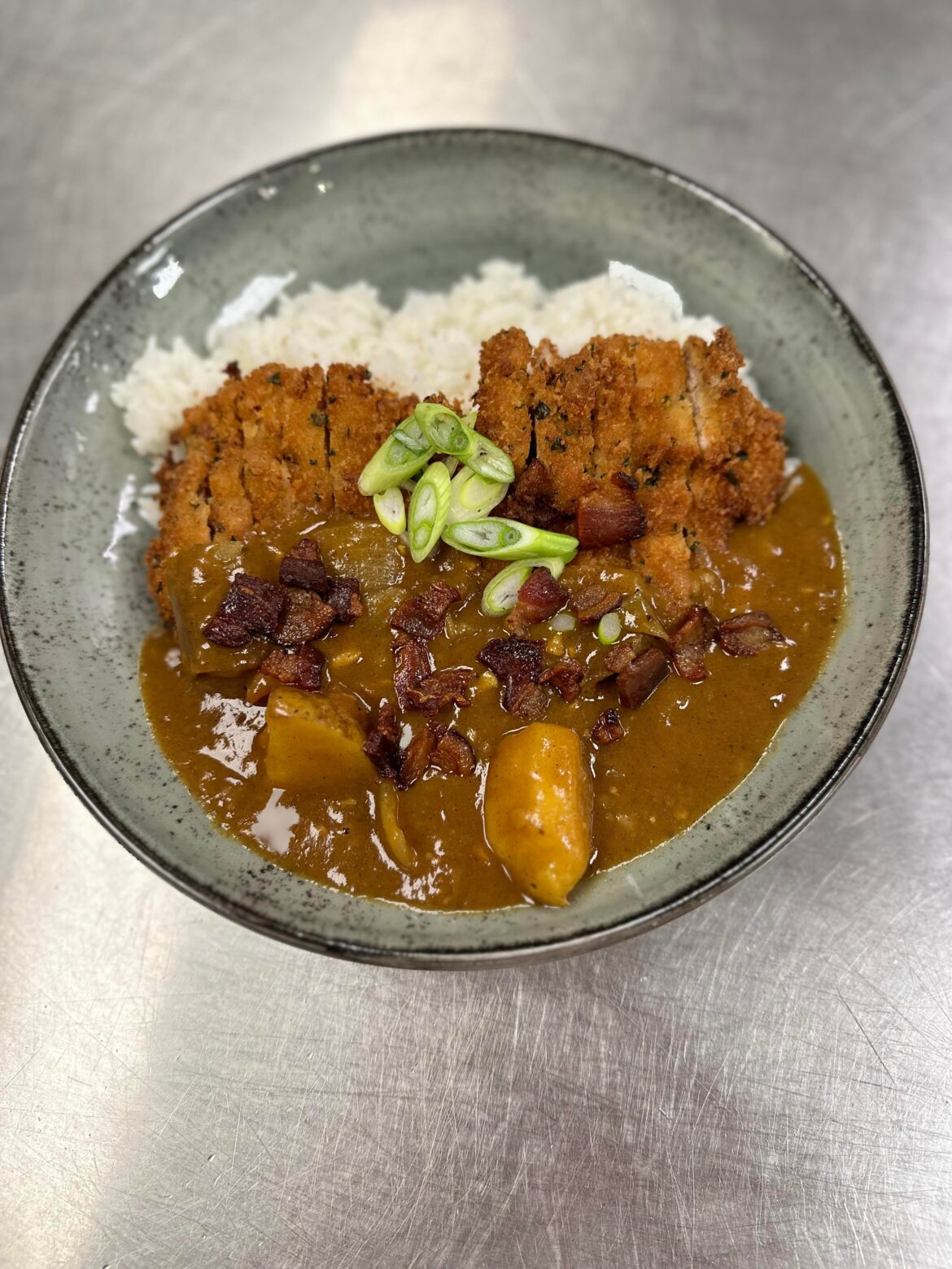 Made some Benton’s Bacon and whiskey chicken katsu curry. Breaded the chicken thigh with thyme and parsley panko and used jack daniels to deglaze. Used Java curry pack, carrots, potatoes, tomatoes, garlic, onions, and bacon fat to sauté.