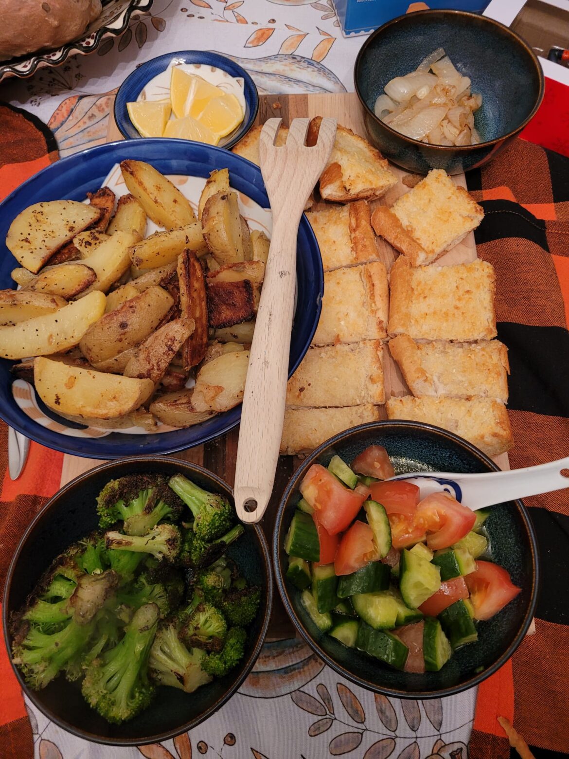 Dinner tonight- Garlic lemon potatoes fried in V butter, garlic bread, tomato + cuke vinagrete, caramelized onions, charred broccoli.