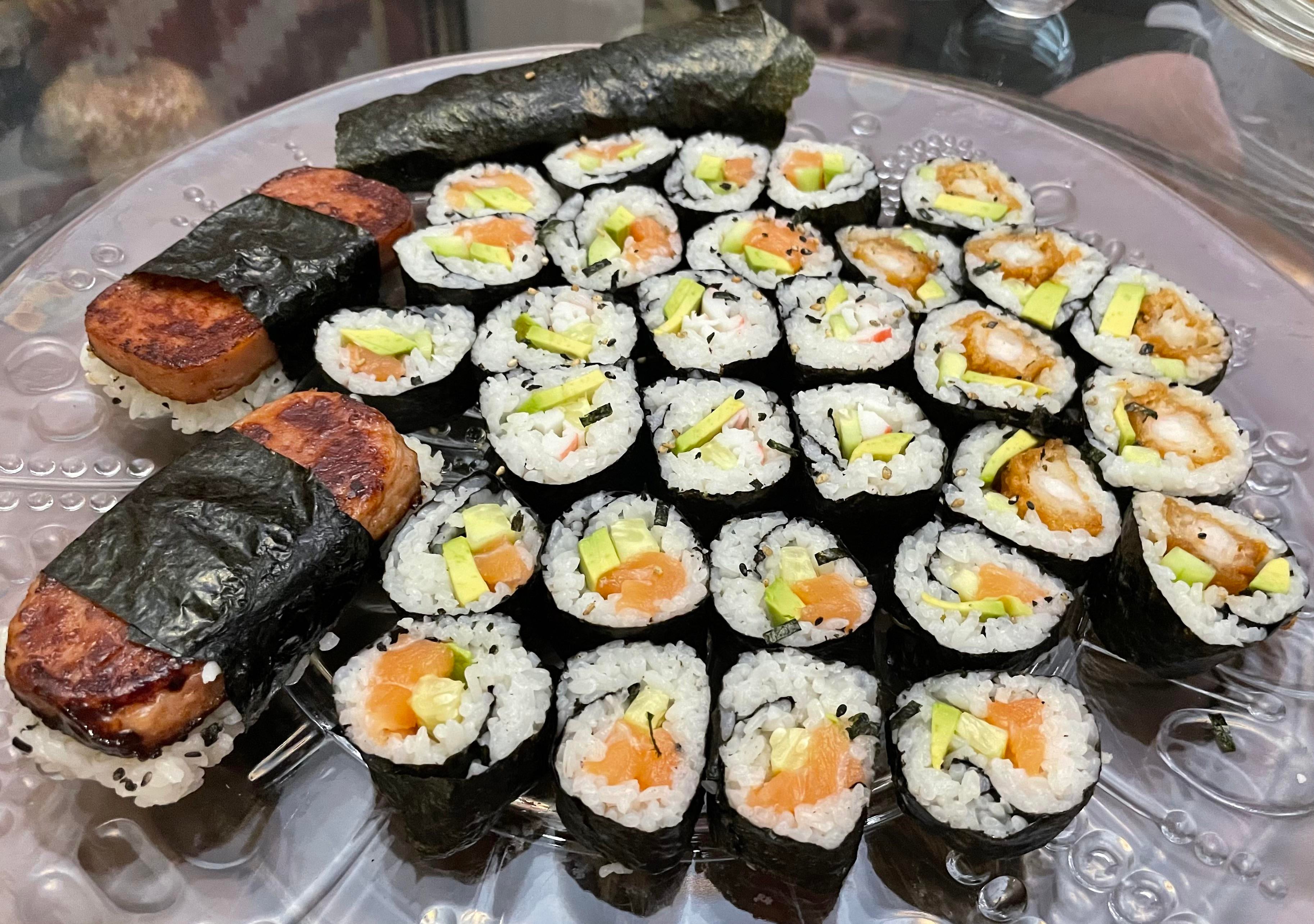 Sushi platter with salmon roll, tempura shrimp roll, california roll