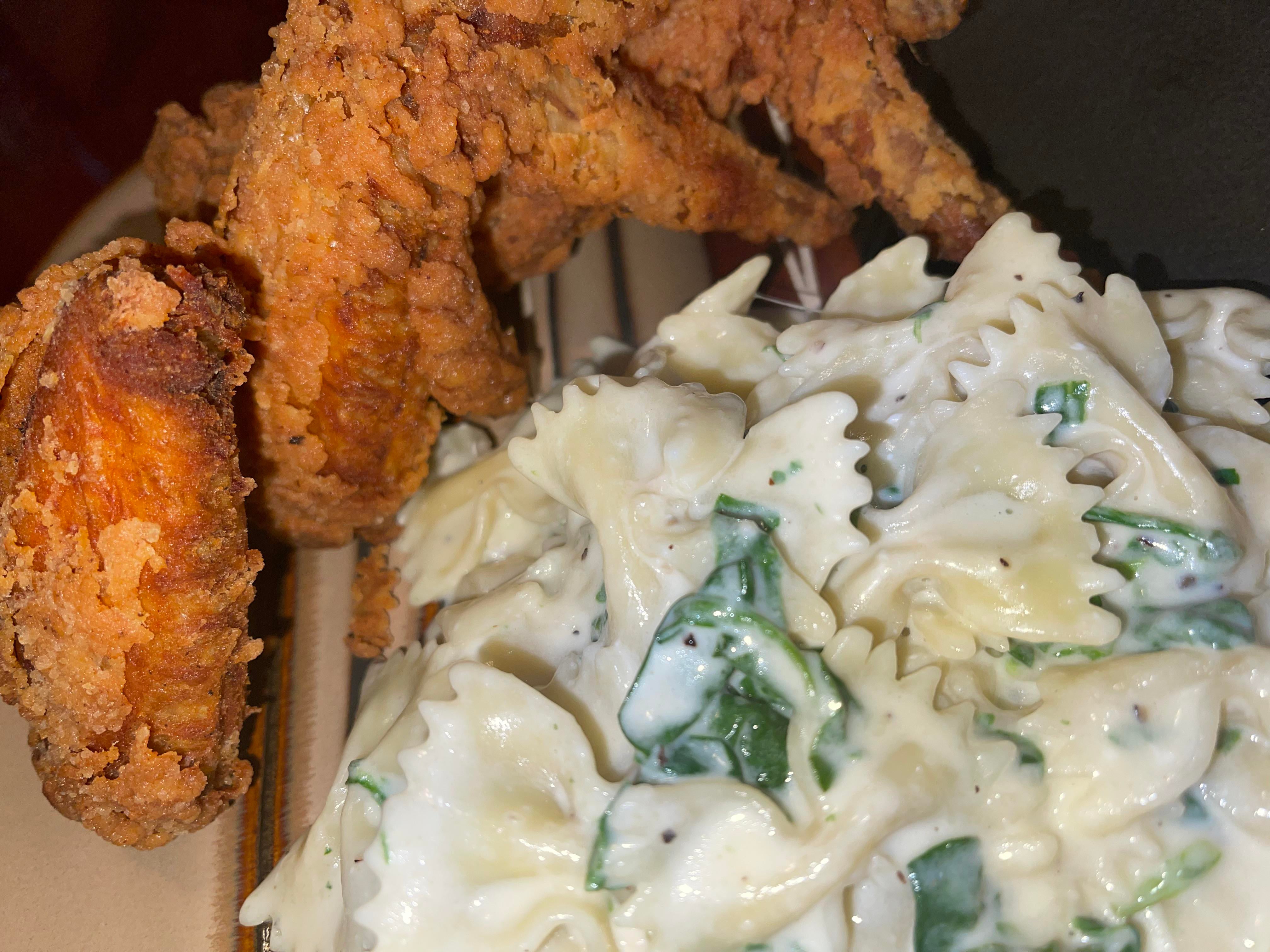 Buttermilk fried chicken with Florentine Alfredo pasta. Dining and