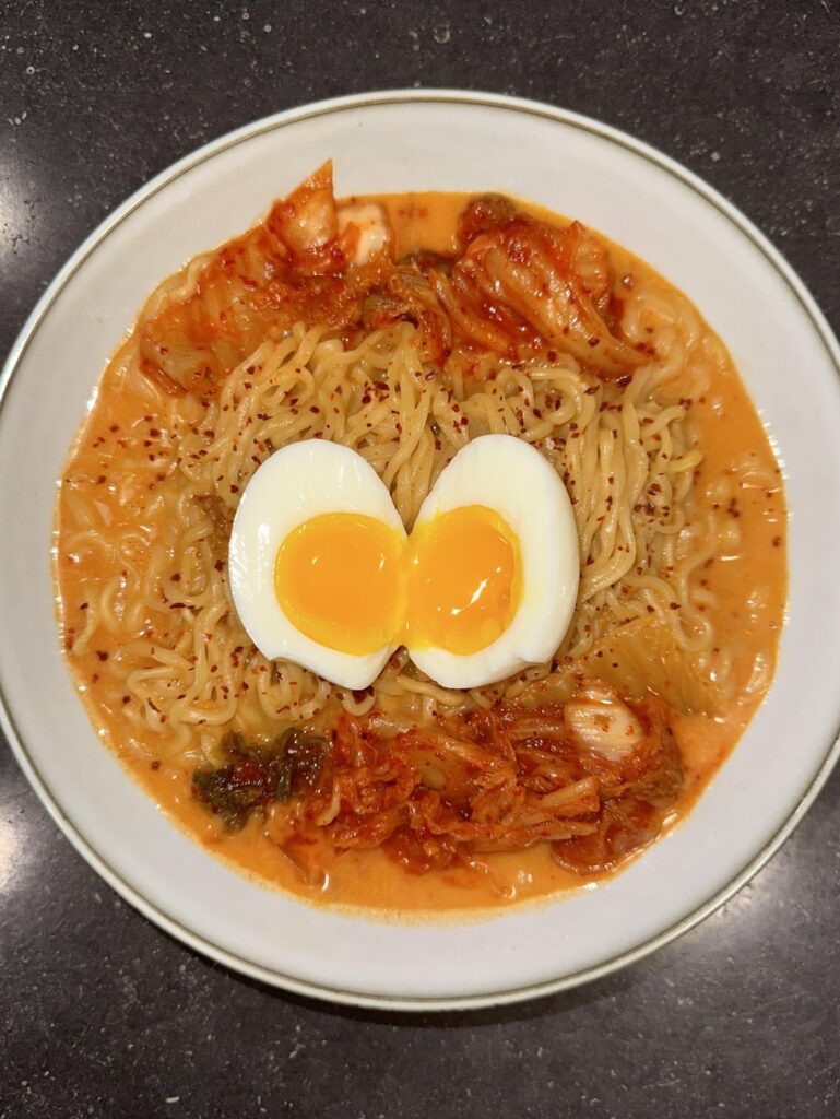 Kimchi Ramen 🍜 topped with egg, gochugaru, and extra kimchi