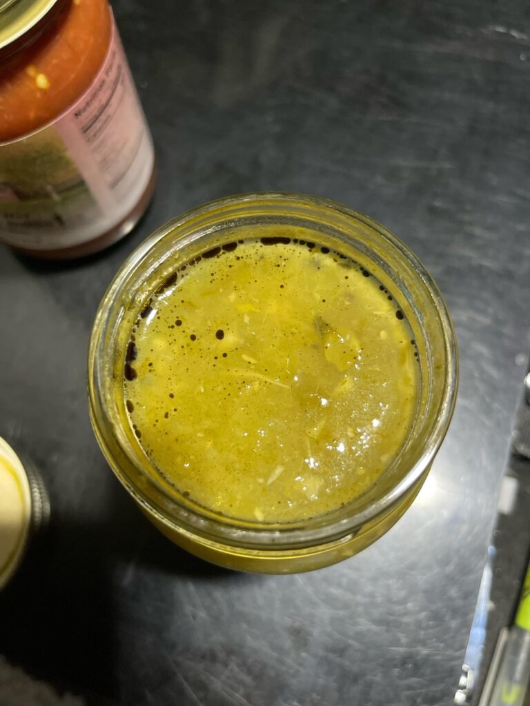 Is it safe to eat? I opened a new jar of salsa tonight and noticed these specs(it’s actually liquid). I bout this at a travel center. Should I toss it?