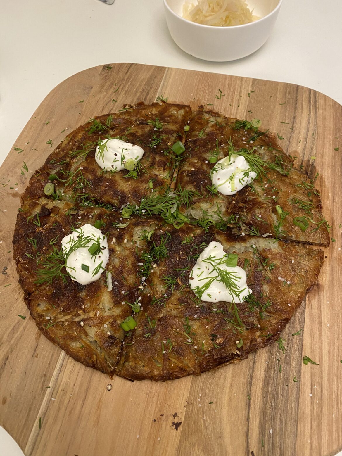 Rösti topped with sour cream and dill.