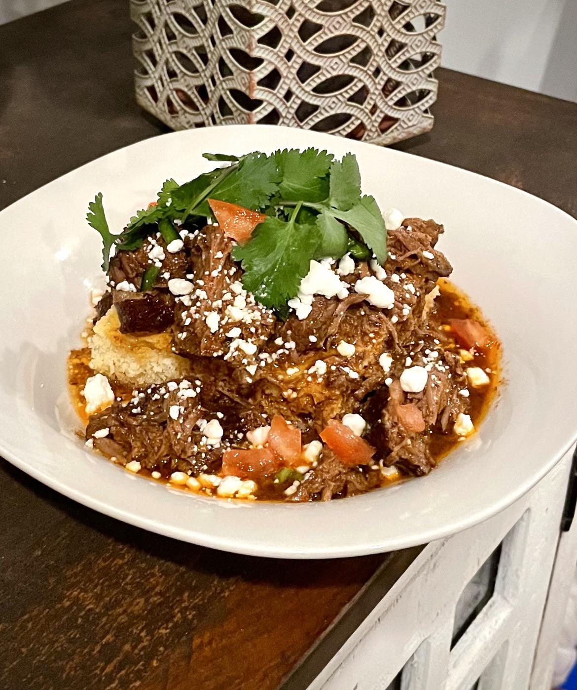 8 hour braised barbacoa over Mexican cornbread with crumbled goat